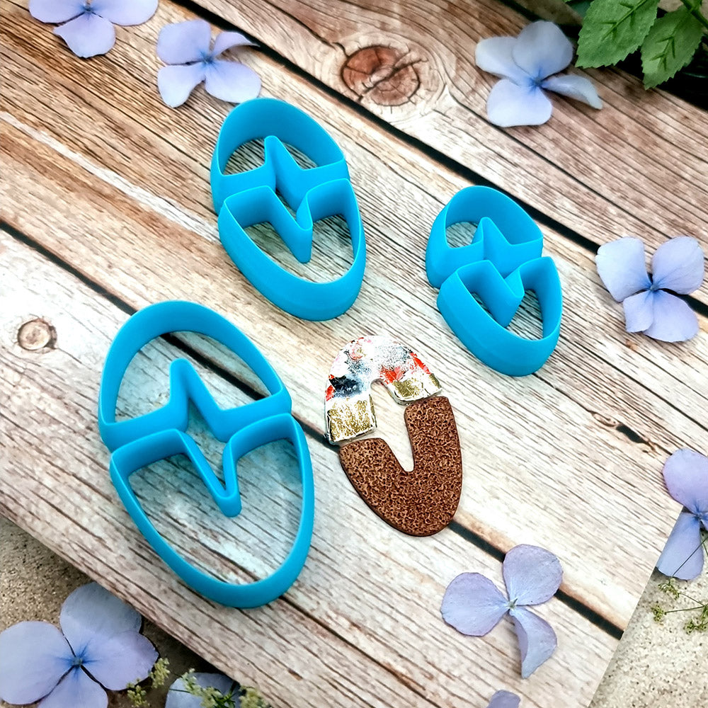 Blue PLA oval U-shape polymer clay cutters in three sizes with finished checkerboard, marbled and glitter clay earring pieces by SweetyBijou