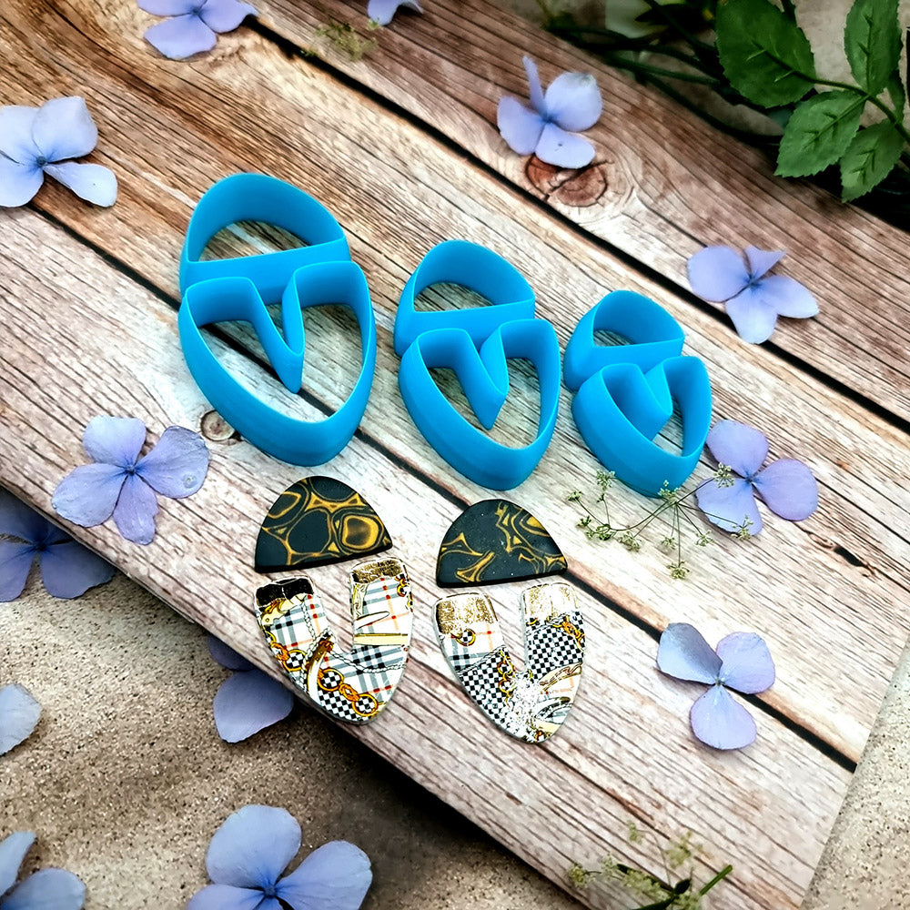 Blue PLA U-shape polymer clay cutters in three sizes cutting a dome cap and U piece, with leopard, plaid and marbled clay pieces by SweetyBijou