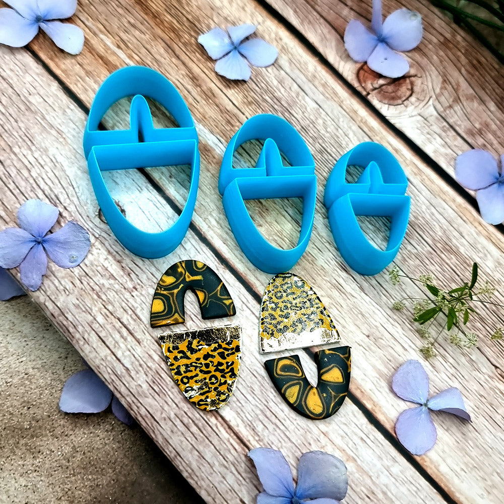 Blue PLA oval polymer clay cutters in three sizes with internal U divider and finished leopard, checkerboard and floral clay pieces by SweetyBijou
