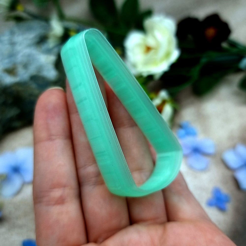 Green PLA long teardrop polymer clay cutter with a pointed top and rounded base, with terracotta clay teardrop earring pieces by SweetyBijou