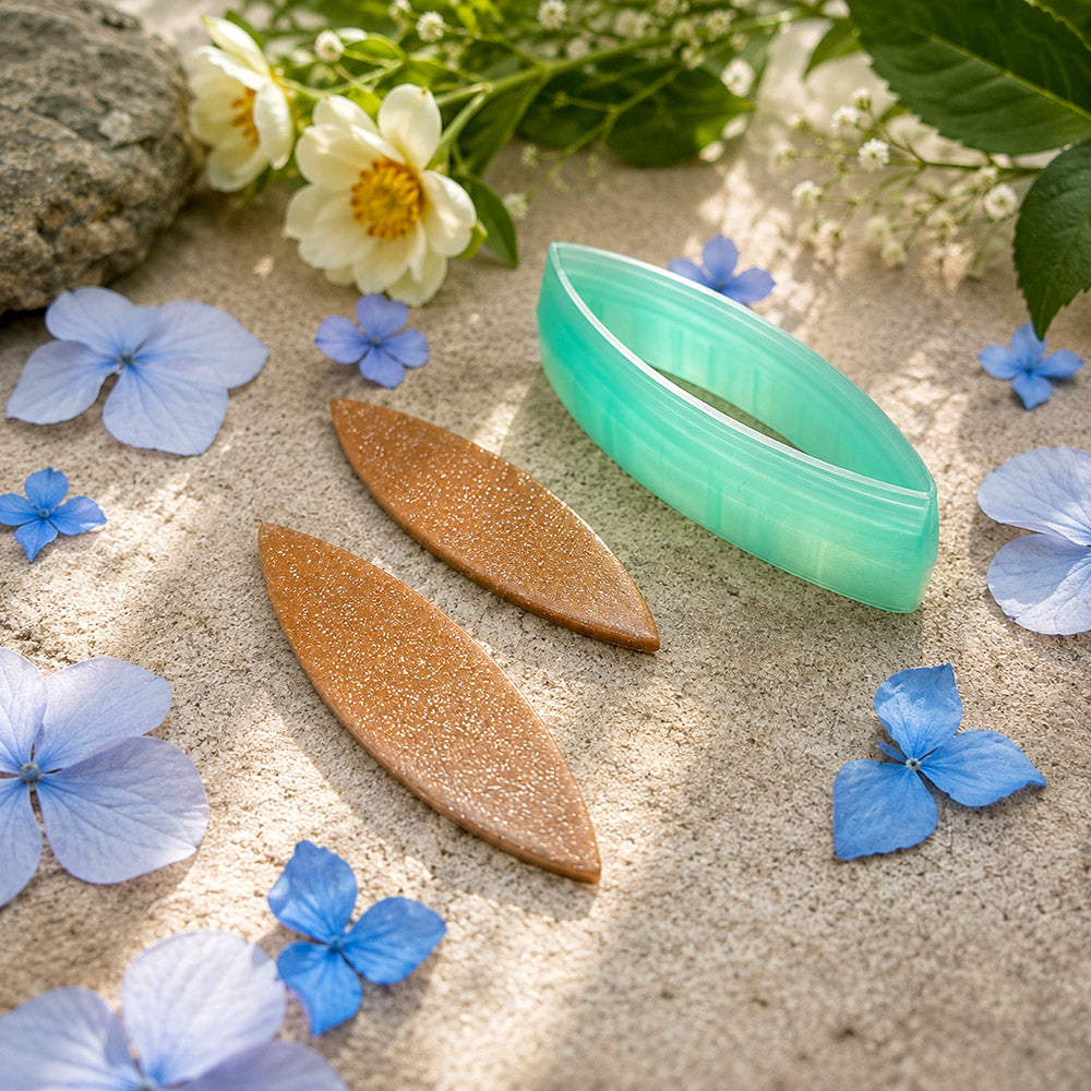 Green PLA broad leaf polymer clay cutter with a pointed marquise outline and terracotta clay leaf earring pieces by SweetyBijou