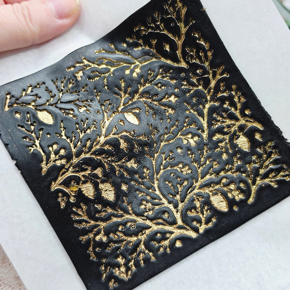 Polymer clay sheet textured with the Bare Winter Branches Christmas texture plate
