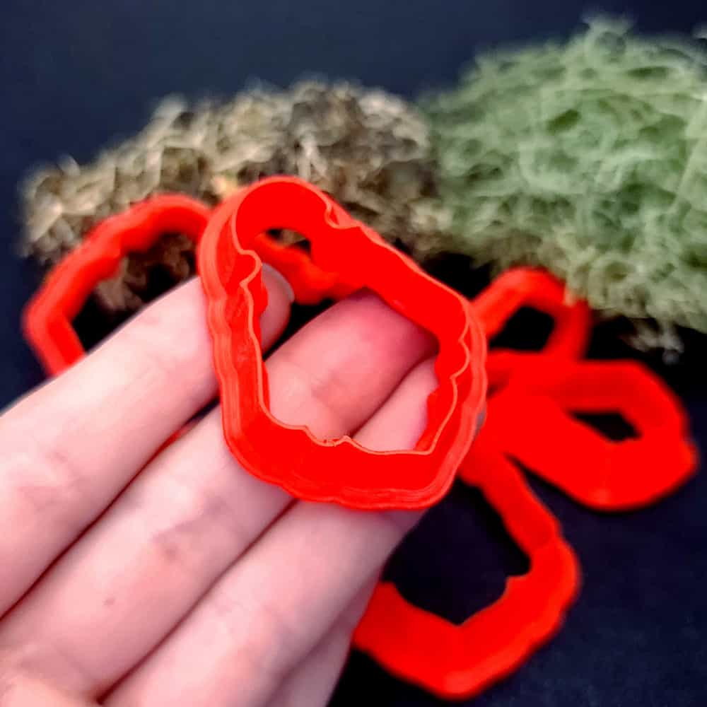 Vintage bell shape polymer clay cutter with curved body and wavy scalloped hem