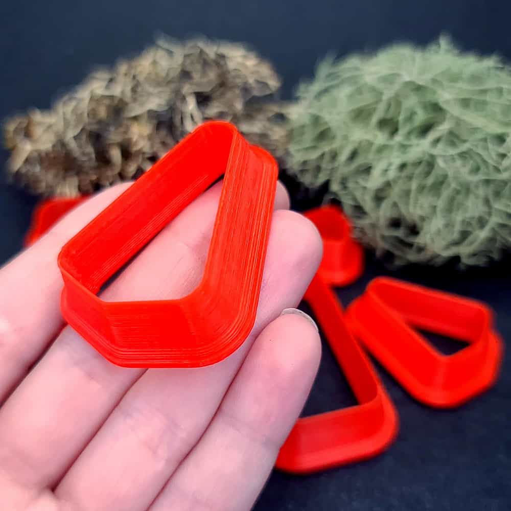 Rounded triangle polymer clay cutter with soft corners and apex at top