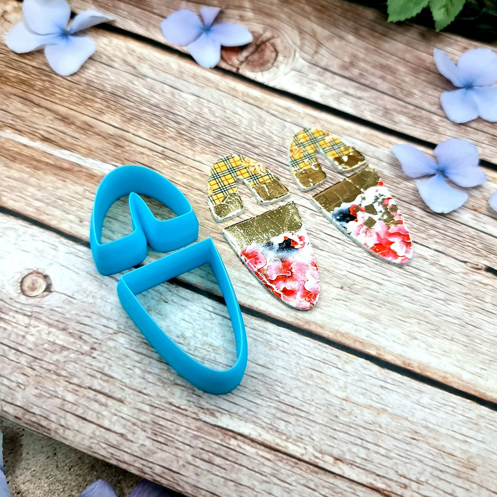 Blue PLA U-shape polymer clay cutters in three sizes cutting an arch band and tapered base, with finished plaid and floral clay pieces by SweetyBijou