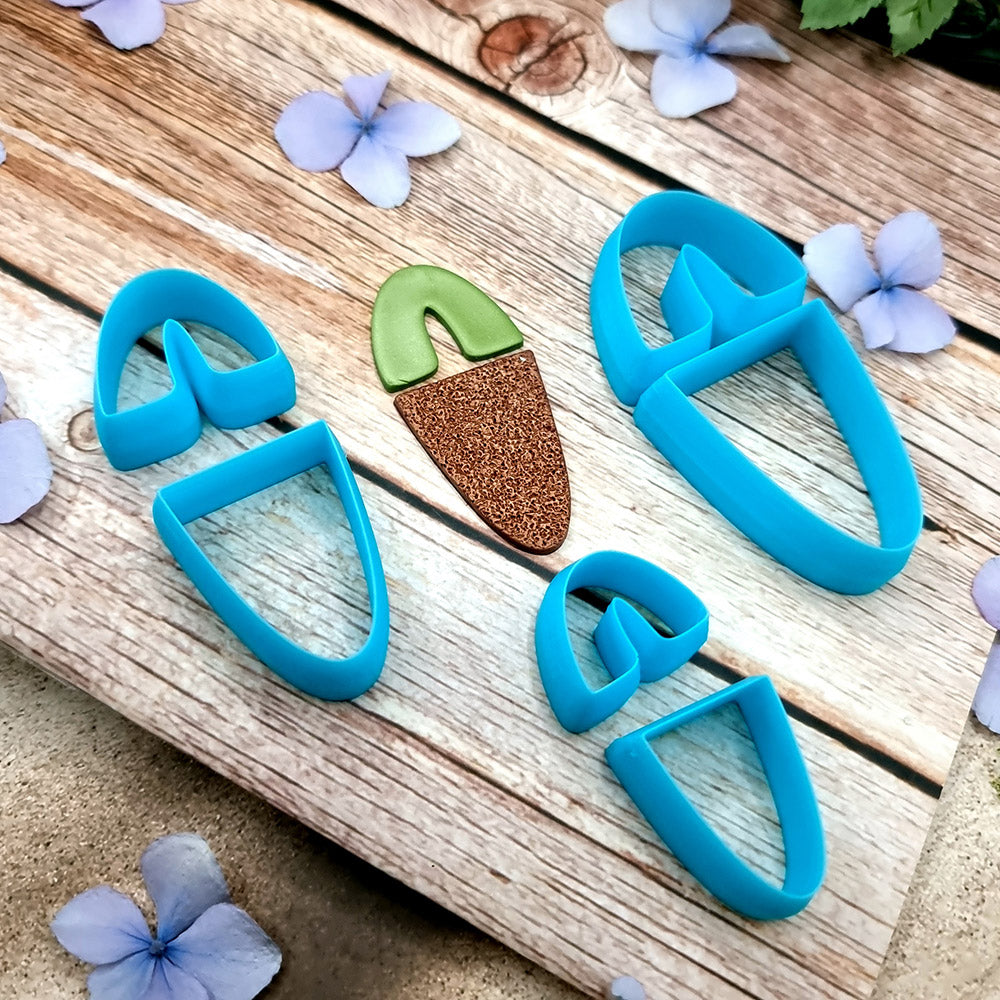 Blue PLA U-shape polymer clay cutters in three sizes cutting an arch band and tapered base, with finished plaid and floral clay pieces by SweetyBijou