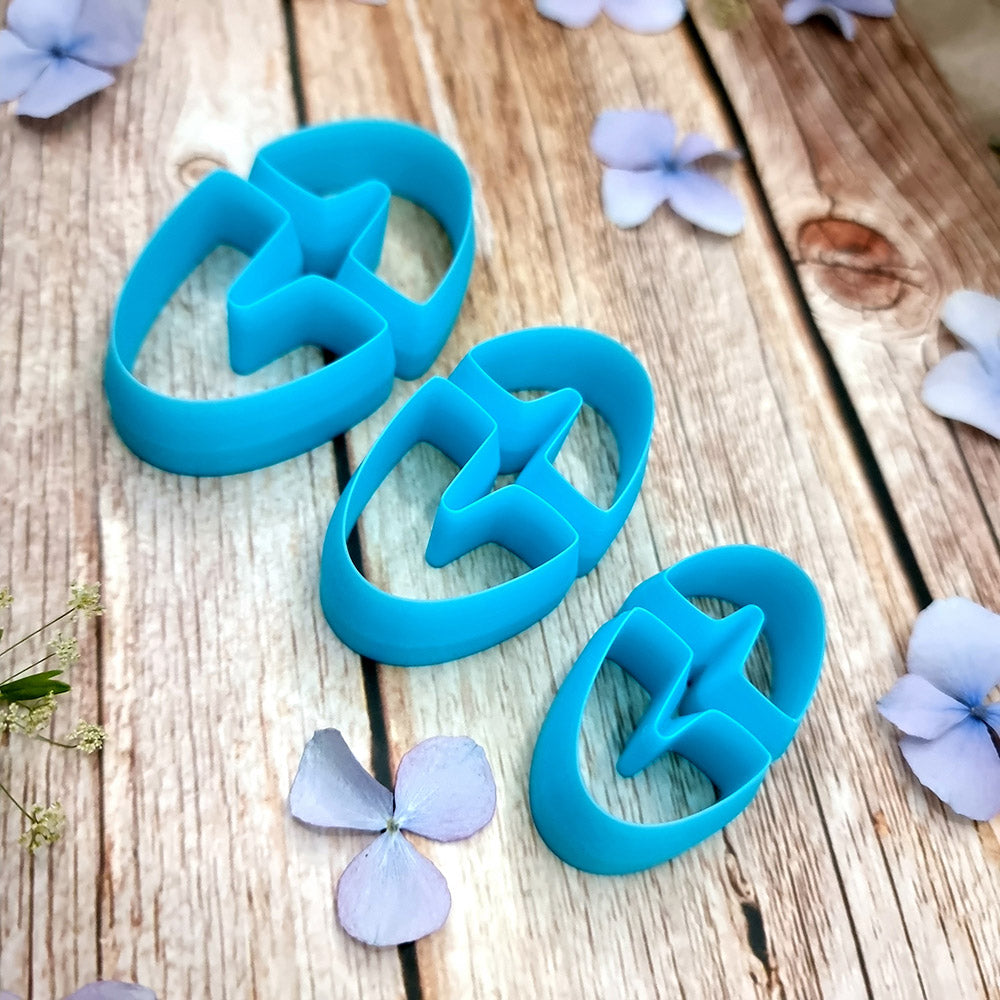 Blue PLA oval U-shape polymer clay cutters in three sizes with finished checkerboard, marbled and glitter clay earring pieces by SweetyBijou