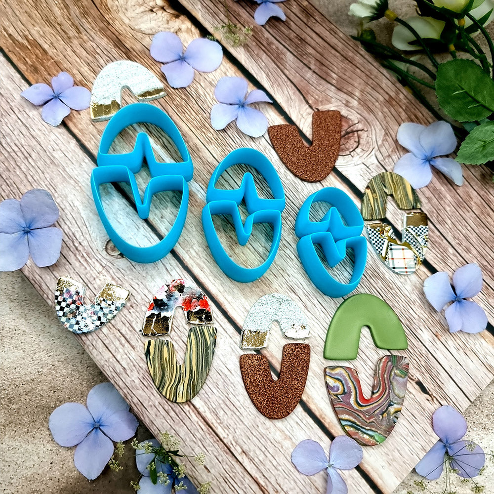 Blue PLA oval U-shape polymer clay cutters in three sizes with finished checkerboard, marbled and glitter clay earring pieces by SweetyBijou