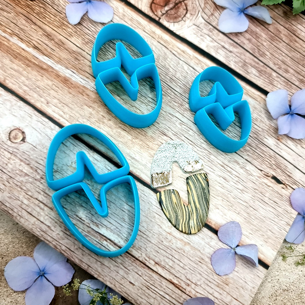 Blue PLA oval U-shape polymer clay cutters in three sizes with finished checkerboard, marbled and glitter clay earring pieces by SweetyBijou