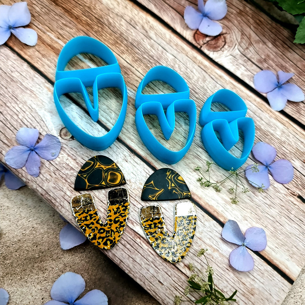 Blue PLA U-shape polymer clay cutters in three sizes cutting a dome cap and U piece, with leopard, plaid and marbled clay pieces by SweetyBijou