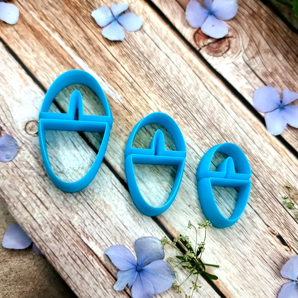 Blue PLA oval polymer clay cutters in three sizes with internal U divider and finished leopard, checkerboard and floral clay pieces by SweetyBijou