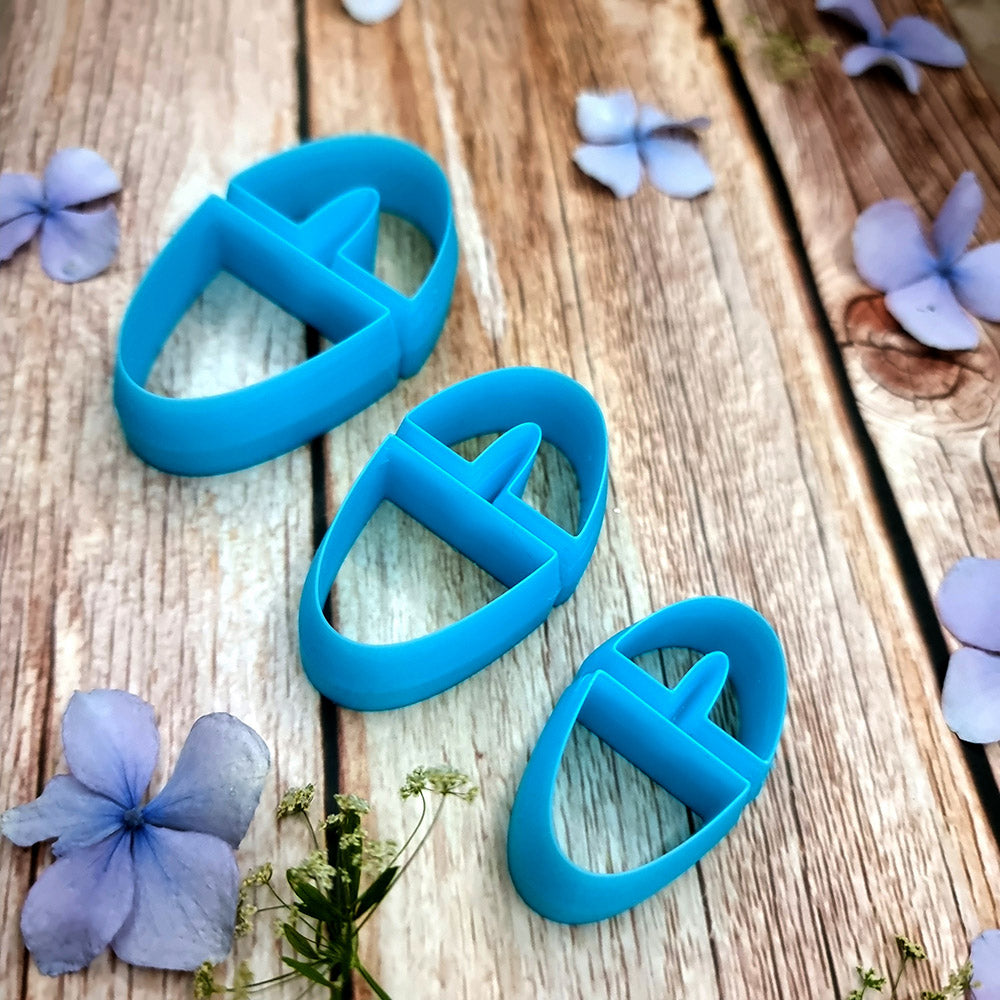 Blue PLA oval polymer clay cutters in three sizes with internal U divider and finished leopard, checkerboard and floral clay pieces by SweetyBijou