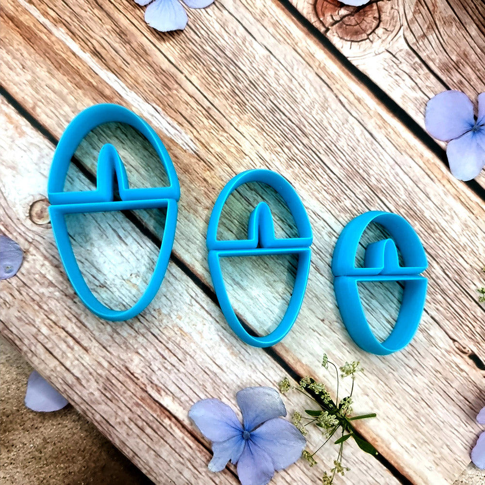 Blue PLA oval polymer clay cutters in three sizes with internal U divider and finished leopard, checkerboard and floral clay pieces by SweetyBijou