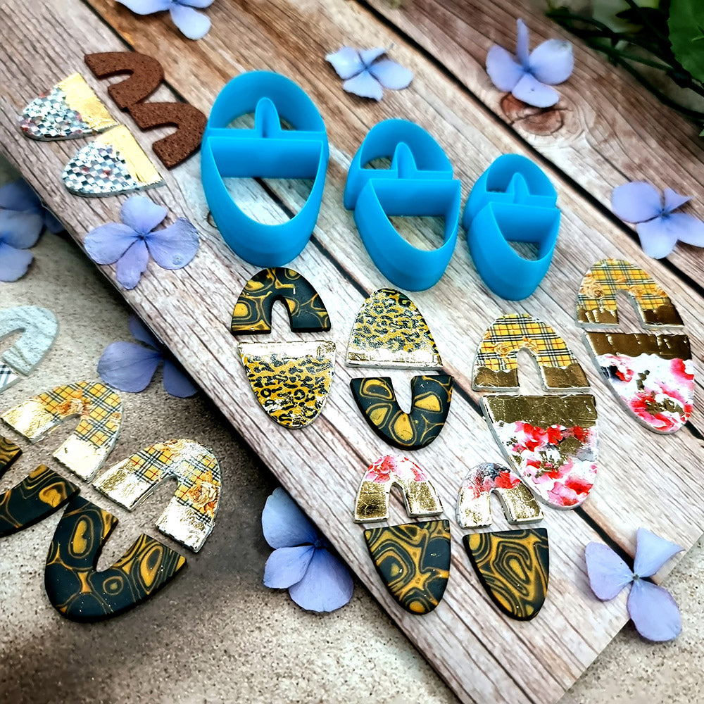 Blue PLA oval polymer clay cutters in three sizes with internal U divider and finished leopard, checkerboard and floral clay pieces by SweetyBijou
