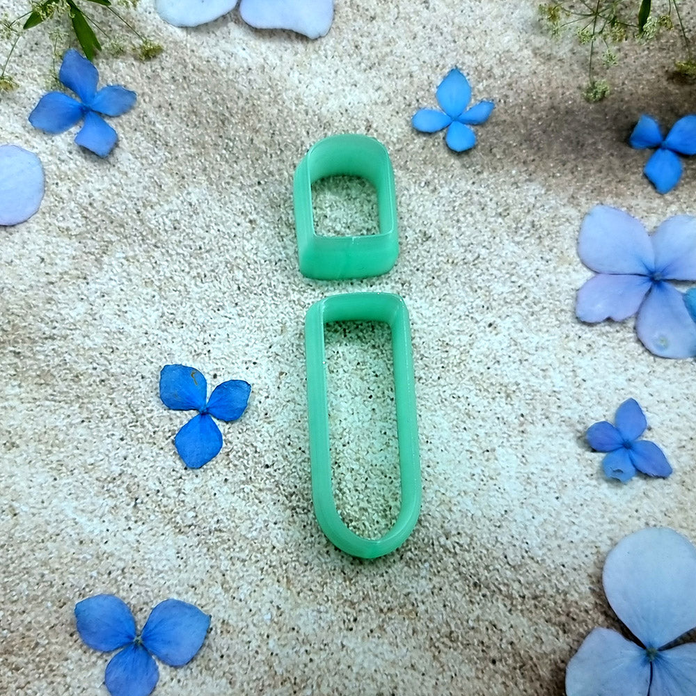 Green PLA stacked bar polymer clay cutter that cuts a small stud and a long rounded bar, with terracotta clay earring pieces by SweetyBijou