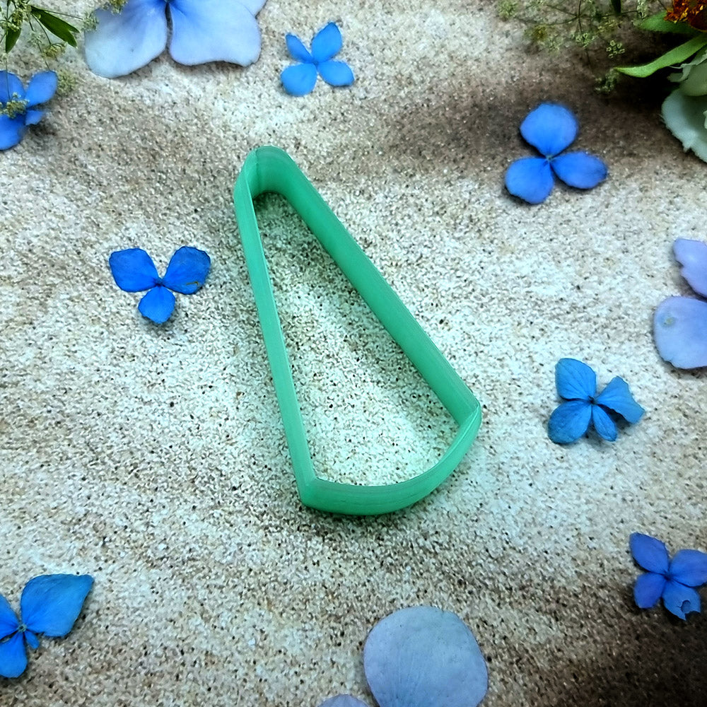 Green PLA slanted wedge polymer clay cutter with a broad angled base and terracotta clay wedge earring pieces by SweetyBijou
