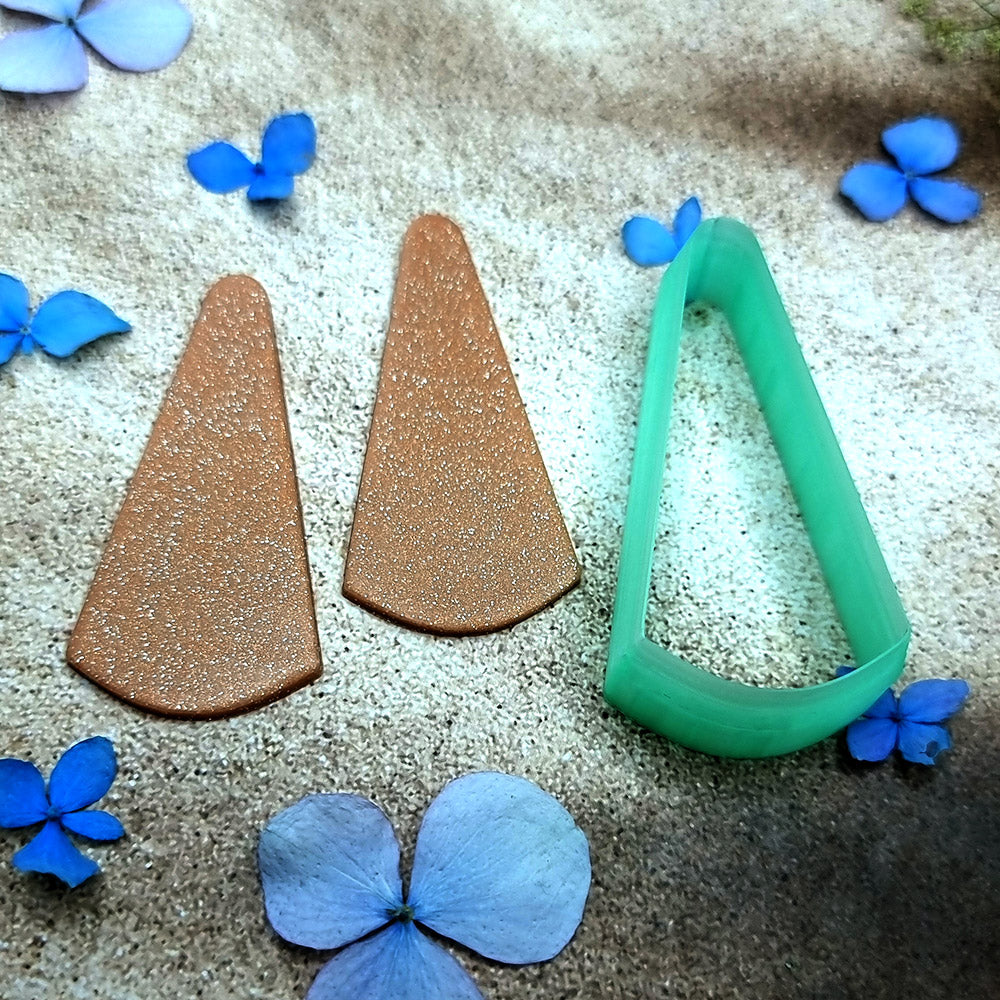 Green PLA slanted wedge polymer clay cutter with a broad angled base and terracotta clay wedge earring pieces by SweetyBijou
