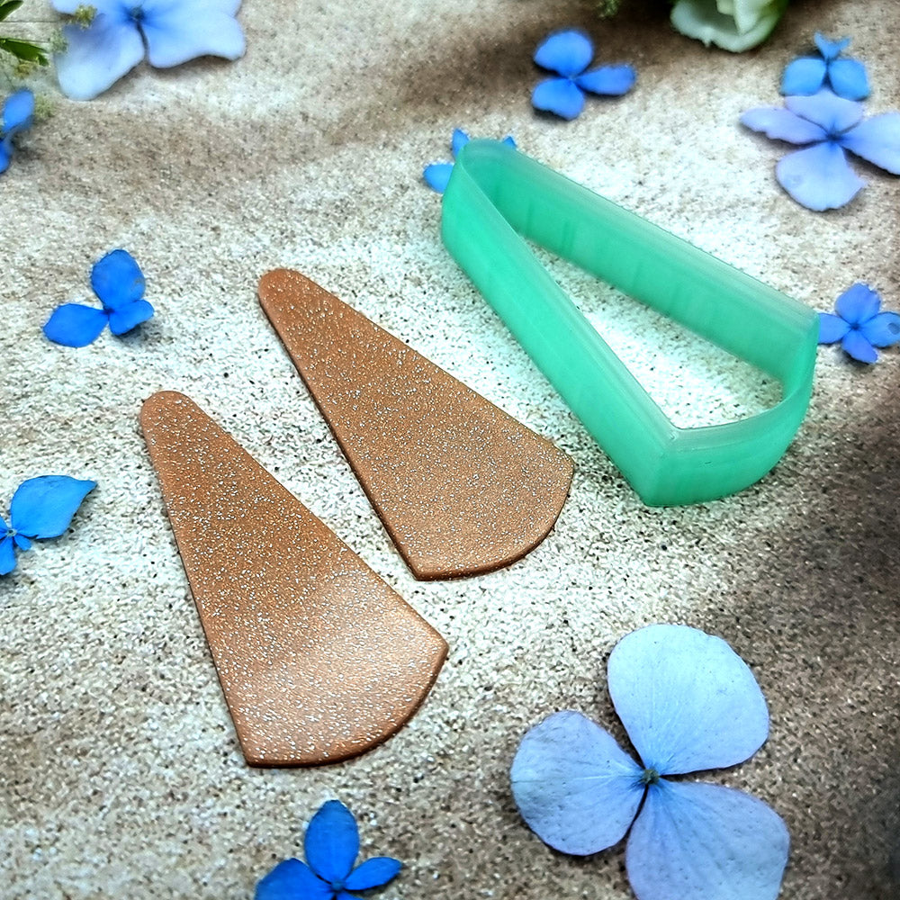 Green PLA slanted wedge polymer clay cutter with a broad angled base and terracotta clay wedge earring pieces by SweetyBijou