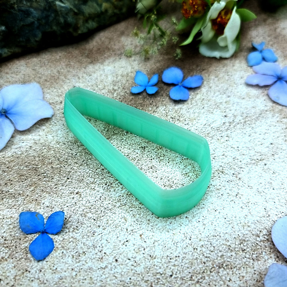 Green PLA long teardrop polymer clay cutter with a pointed top and rounded base, with terracotta clay teardrop earring pieces by SweetyBijou