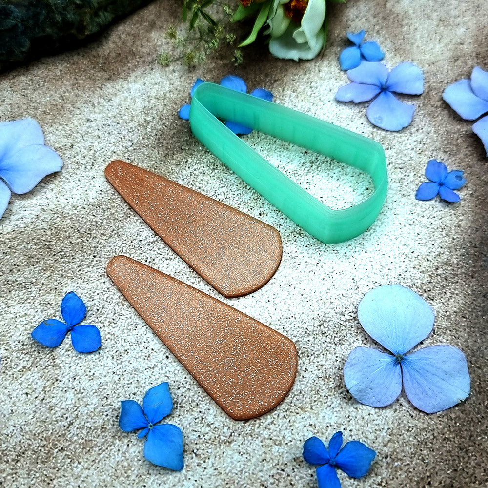 Green PLA long teardrop polymer clay cutter with a pointed top and rounded base, with terracotta clay teardrop earring pieces by SweetyBijou