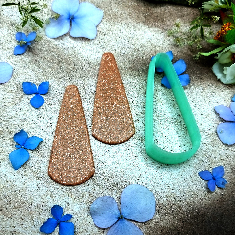 Green PLA long teardrop polymer clay cutter with a pointed top and rounded base, with terracotta clay teardrop earring pieces by SweetyBijou