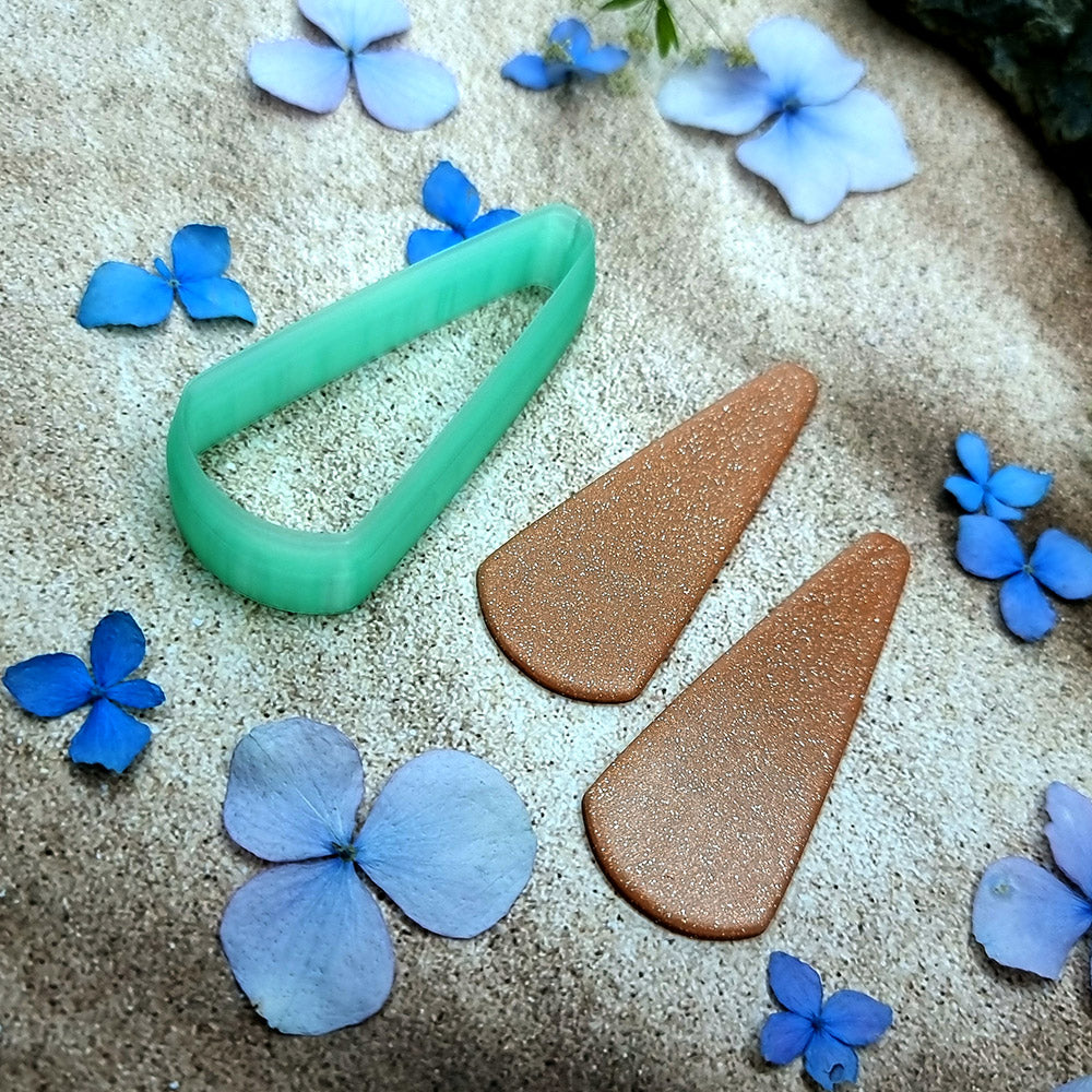 Green PLA long teardrop polymer clay cutter with a pointed top and rounded base, with terracotta clay teardrop earring pieces by SweetyBijou