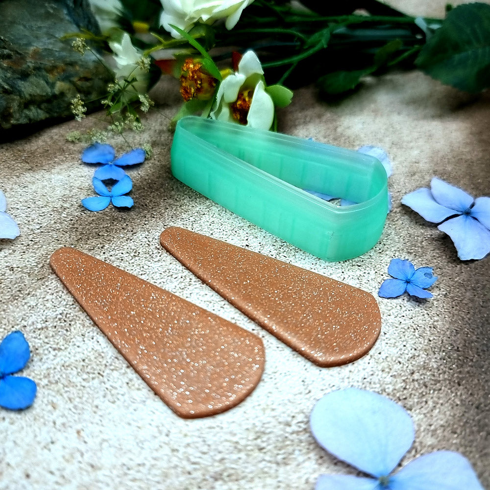 Green PLA long teardrop polymer clay cutter with a pointed top and rounded base, with terracotta clay teardrop earring pieces by SweetyBijou