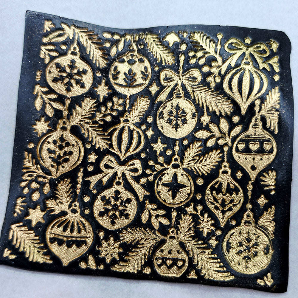 Polymer clay sheet textured with the Christmas Ornaments Christmas texture plate