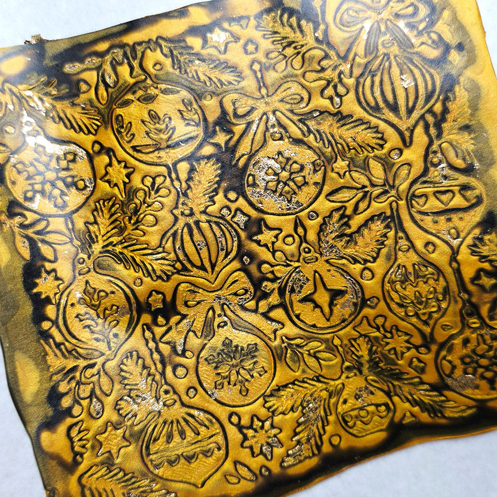 Polymer clay sheet textured with the Christmas Ornaments Christmas texture plate