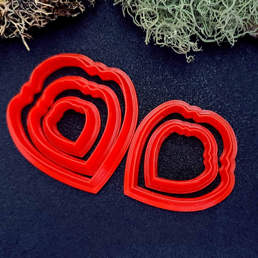 Scalloped teardrop polymer clay cutter with lobed top and wavy scalloped edges