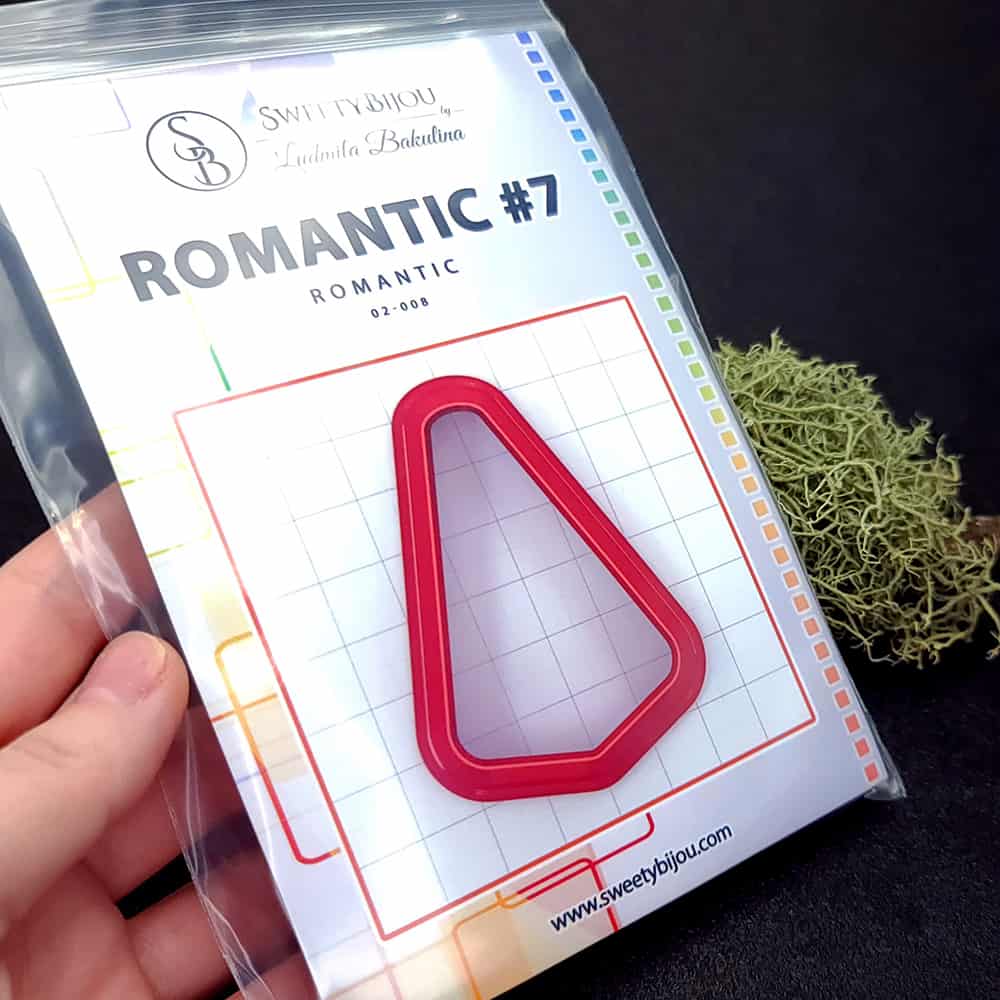 Rounded triangle polymer clay cutter with soft corners and apex at top