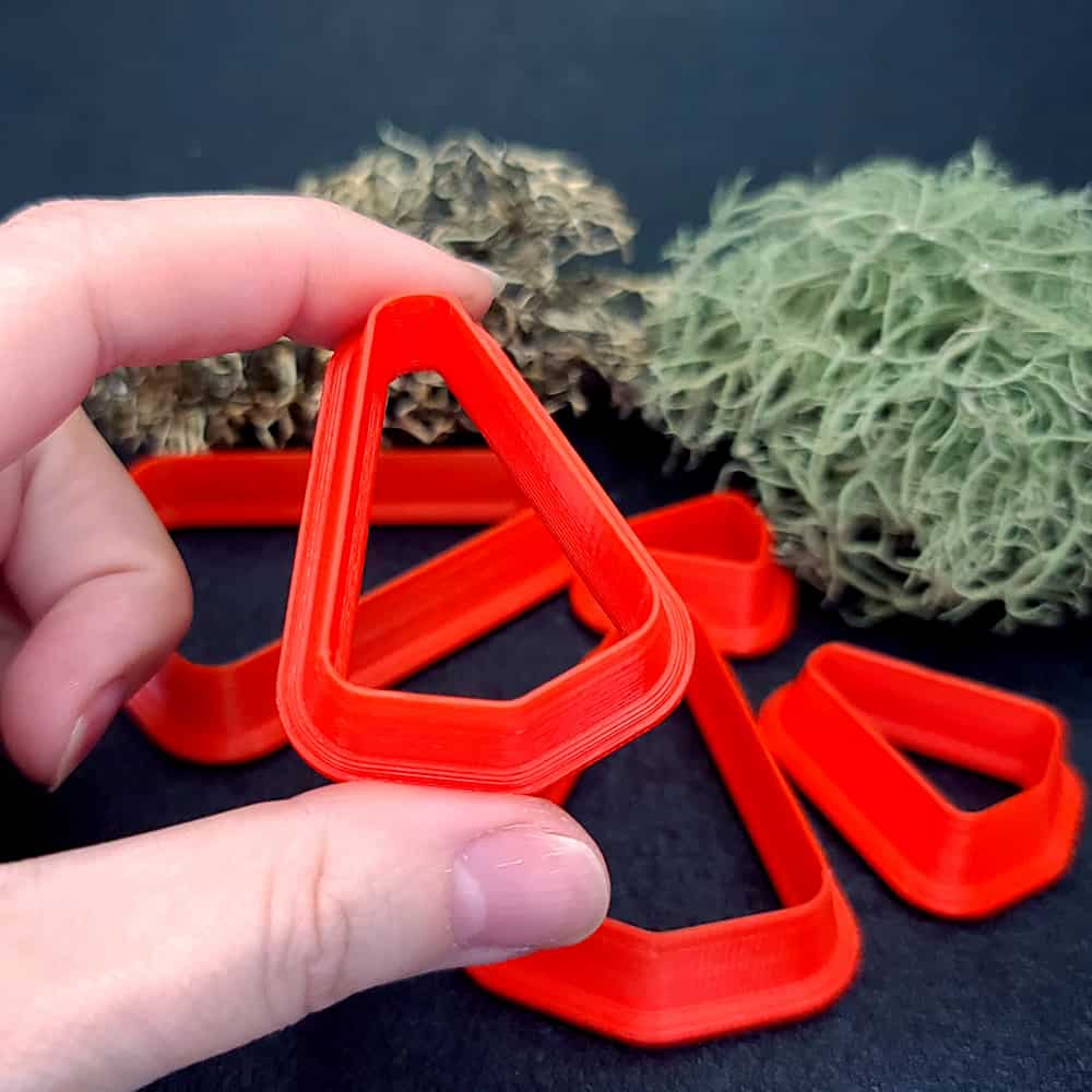 Rounded triangle polymer clay cutter with soft corners and apex at top